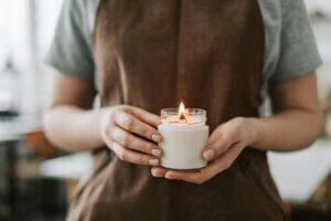 woman holding a lit homemade candle