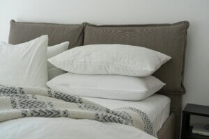 bed topped with organic cotton bed sheets