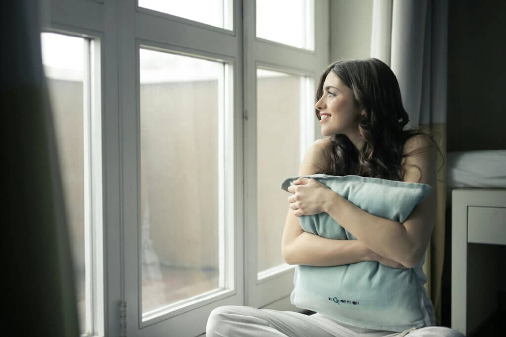 woman looking out of a streak-free window